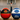 Custom basketballs with team logos and sponsor branding displayed on an indoor court